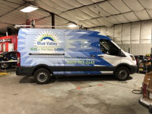 Company van with a full vehicle graphics wrap installed by 303 Sign Company to increase brand visibility and mobile advertising impact.