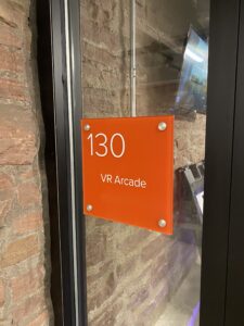 Interior wayfinding ADA Signs with Braille and raised lettering installed in a commercial building to improve accessibility and navigation.